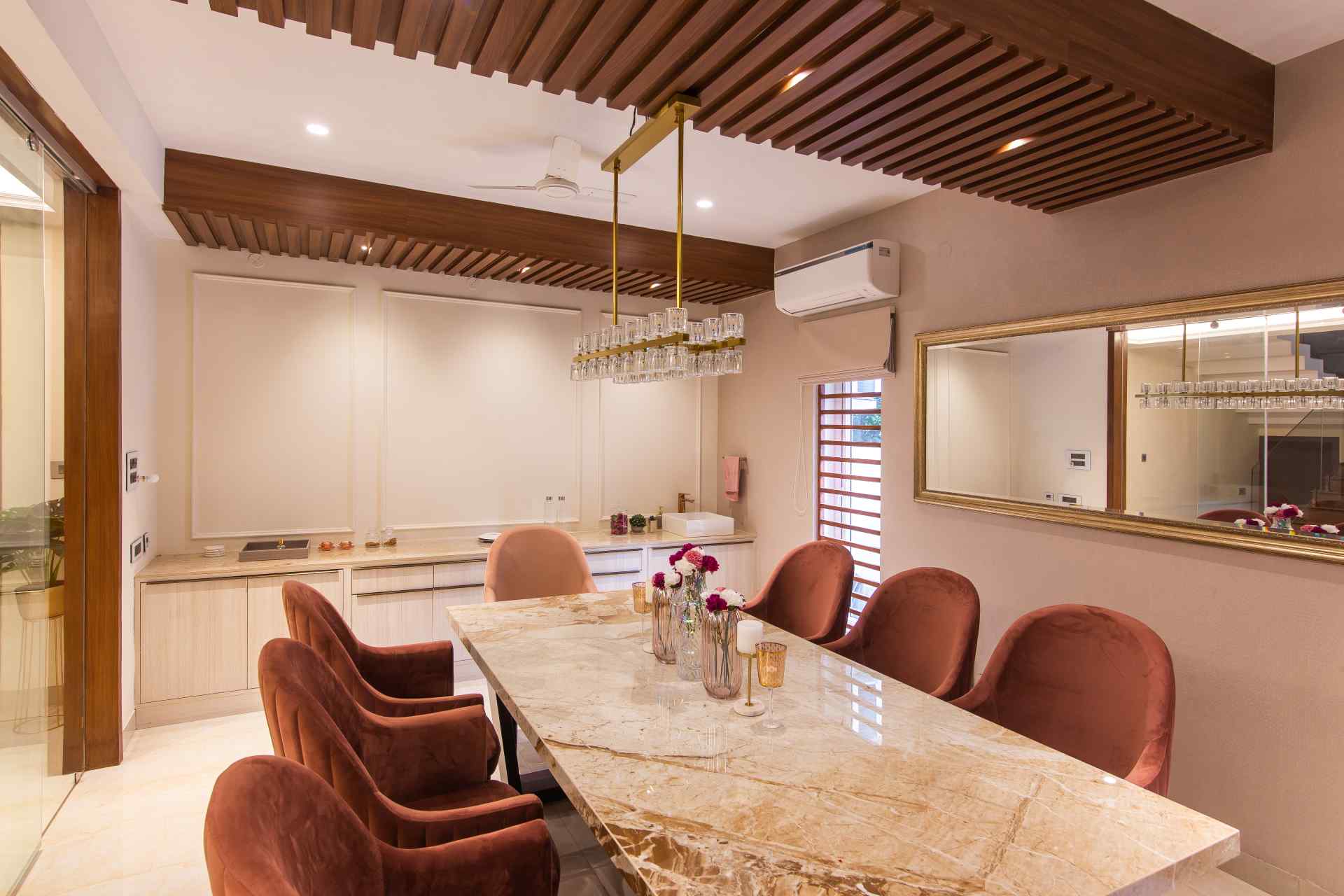 Offcentered Infrastructure's beautifully designed dining room with furniture and trendy roof and lights.