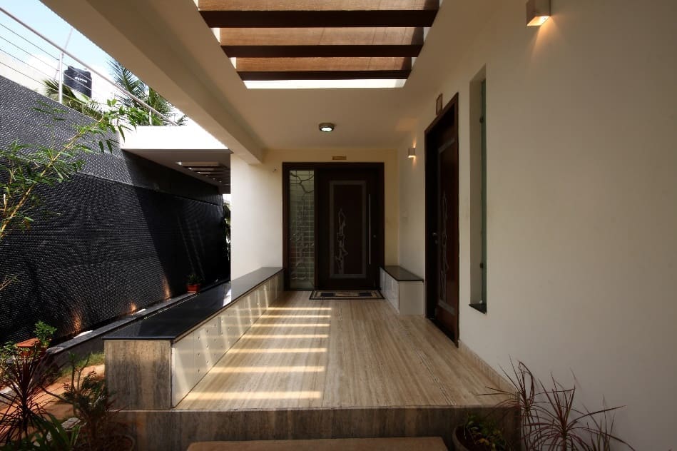 Entrance to a house with a wall fountain designed by Offcentered Infrastructure.
